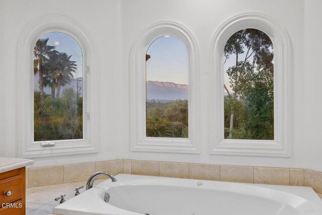 12986 Macdonald Dr, Ojai, CA 93023 - full bathroom with a tub with jets, healthy amount of natural light, and vanity