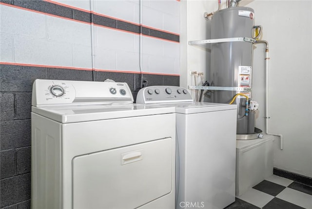 917 W Imperial Unit 64, La Habra, CA 90631 - laundry room with secured water heater, washing machine and dryer, concrete block wall, and tile patterned floors