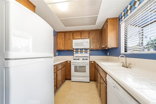 917 W Imperial Unit 64, La Habra, CA 90631 - kitchen with white appliances, a sink, brown cabinetry, tile counters, and light tile patterned floors