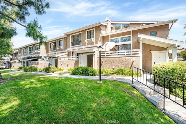 917 W Imperial Unit 64, La Habra, CA 90631 - view of front of home with stucco siding and a front lawn