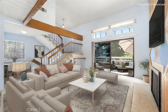 917 W Imperial Unit 64, La Habra, CA 90631 - living room with high vaulted ceiling, plenty of natural light, stairway, a fireplace, and beam ceiling
