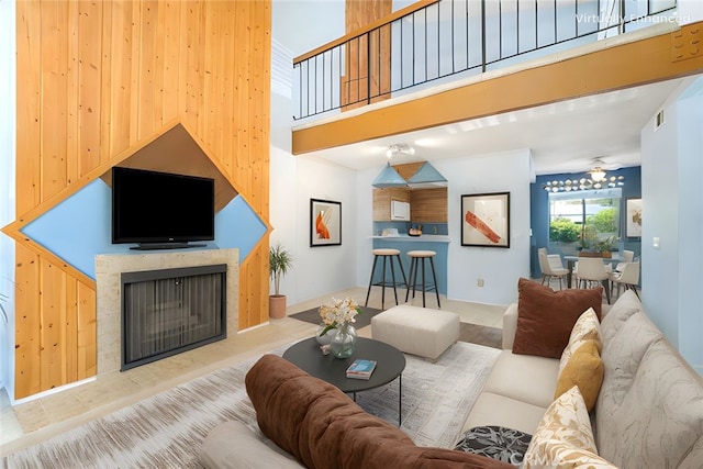 917 W Imperial Unit 64, La Habra, CA 90631 - living area featuring a fireplace with raised hearth, wood finished floors, and a towering ceiling
