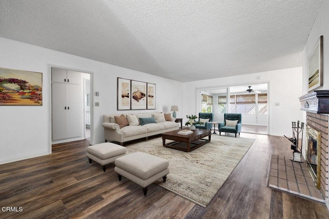 203 E Garden Grn, Port Hueneme, CA 93041 - living room with dark wood-type flooring, a brick fireplace, a textured ceiling, and a ceiling fan