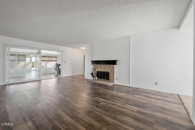 203 E Garden Grn, Port Hueneme, CA 93041 - unfurnished living room featuring a textured ceiling, wood finished floors, a brick fireplace, and a ceiling fan