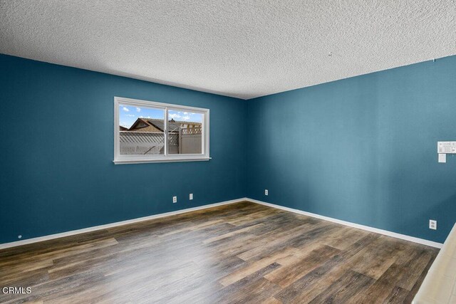 203 E Garden Grn, Port Hueneme, CA 93041 - empty room with wood finished floors, a textured ceiling, and baseboards