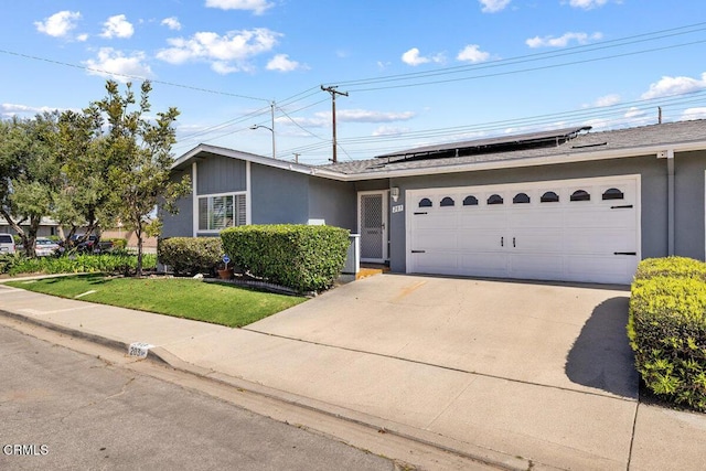 203 E Garden Grn, Port Hueneme, CA 93041 - view of front of home featuring stucco siding, roof mounted solar panels, driveway, and an attached garage