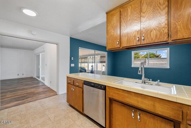 203 E Garden Grn, Port Hueneme, CA 93041 - kitchen with dishwasher, a sink, brown cabinetry, and tile counters