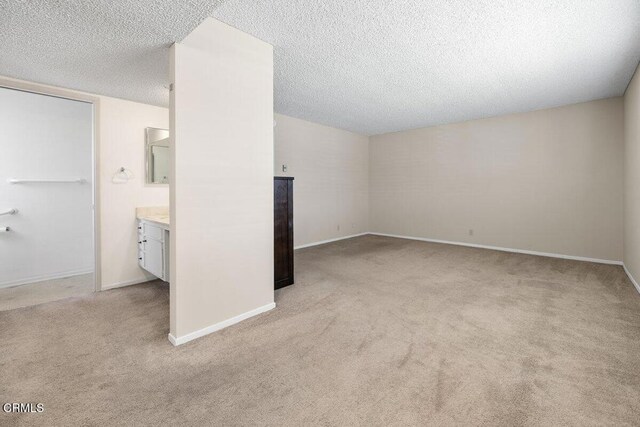 203 E Garden Grn, Port Hueneme, CA 93041 - additional living space with light carpet, baseboards, and a textured ceiling