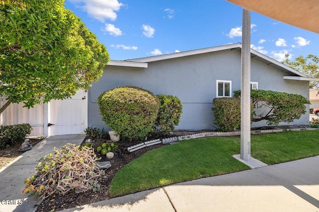 203 E Garden Grn, Port Hueneme, CA 93041 - view of home's exterior featuring stucco siding and a yard