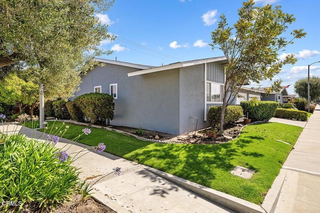 203 E Garden Grn, Port Hueneme, CA 93041 - view of side of property with stucco siding and a yard