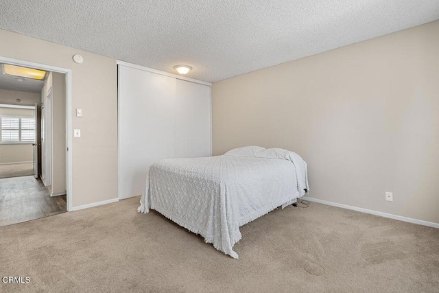 203 E Garden Grn, Port Hueneme, CA 93041 - bedroom with carpet, a textured ceiling, a closet, and baseboards