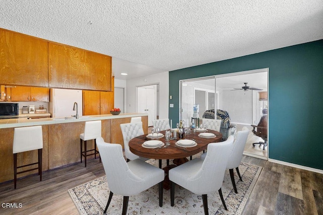 203 E Garden Grn, Port Hueneme, CA 93041 - dining room with a textured ceiling, dark wood-type flooring, a ceiling fan, and baseboards