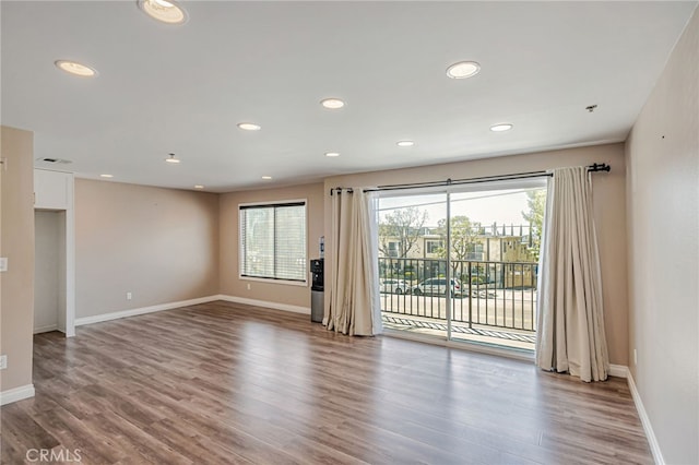 10290 Tujunga Canyon Blvd Unit 102, Tujunga, CA 91402 - empty room with healthy amount of natural light, wood finished floors, baseboards, and recessed lighting