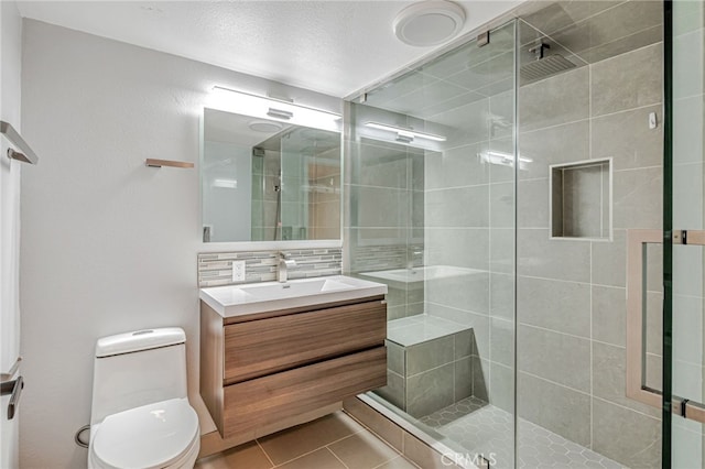 10290 Tujunga Canyon Blvd Unit 102, Tujunga, CA 91402 - bathroom featuring a shower stall, tile patterned floors, toilet, and vanity