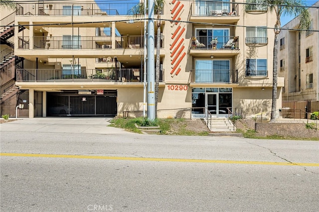 10290 Tujunga Canyon Blvd Unit 102, Tujunga, CA 91402 - view of apartment building / complex with driveway and an attached garage