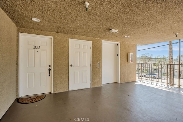 10290 Tujunga Canyon Blvd Unit 102, Tujunga, CA 91402 - view of exterior entry featuring stucco siding, a balcony, a security system, and elevator