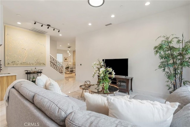 living room featuring recessed lighting, rail lighting, stairway, and marble finish floors