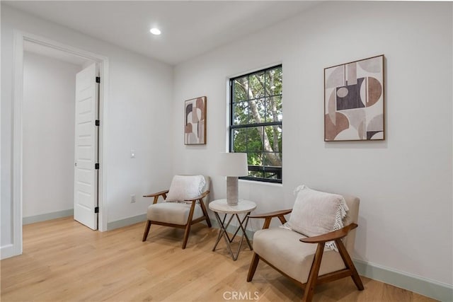 sitting room featuring light wood-style flooring, baseboards, and recessed lighting
