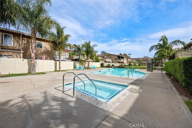 3936 W 5th St Unit 44, Santa Ana, CA 92703 - community pool featuring a hot tub, fence, a patio area, and a residential view
