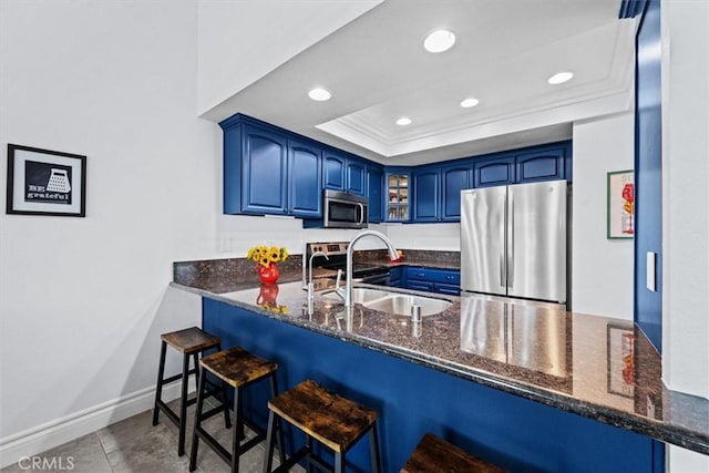 3936 W 5th St Unit 44, Santa Ana, CA 92703 - kitchen featuring appliances with stainless steel finishes, blue cabinetry, a peninsula, recessed lighting, and ornamental molding