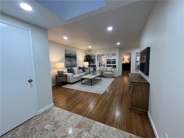 living area featuring baseboards, recessed lighting, and wood finished floors