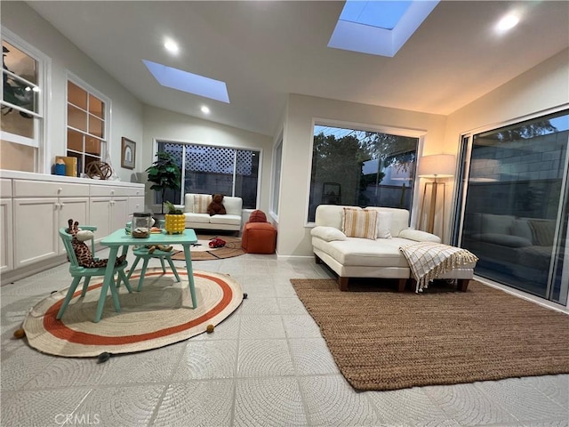 living room featuring a skylight, vaulted ceiling, and recessed lighting