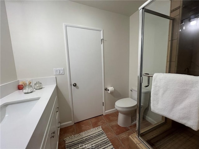 bathroom featuring a stall shower, toilet, tile patterned flooring, and vanity