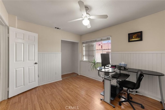 23838 Spring Branch Ct, Murrieta, CA 92562 - office area featuring wood finished floors, a wainscoted wall, and a ceiling fan