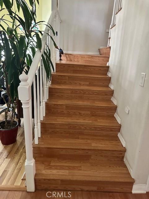 23838 Spring Branch Ct, Murrieta, CA 92562 - stairs with wood finished floors and baseboards