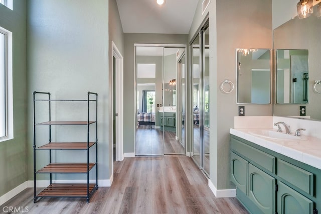 10025 Thornbird Ct, Moreno Valley, CA 92557 - bathroom featuring wood finished floors, vanity, and baseboards