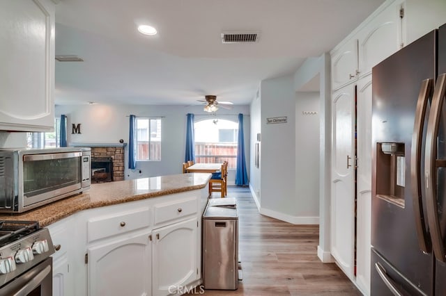 10025 Thornbird Ct, Moreno Valley, CA 92557 - kitchen featuring stainless steel appliances, white cabinetry, light wood-style flooring, a ceiling fan, and recessed lighting