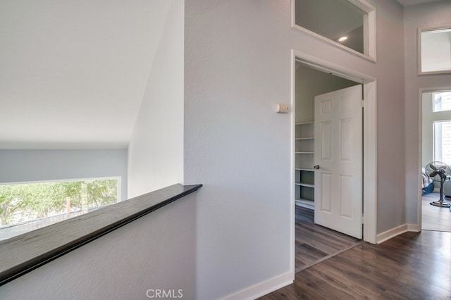 10025 Thornbird Ct, Moreno Valley, CA 92557 - hallway with healthy amount of natural light, baseboards, and dark wood-style floors