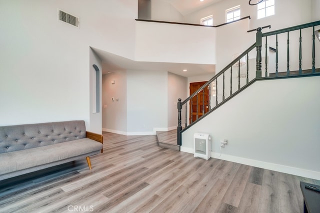 10025 Thornbird Ct, Moreno Valley, CA 92557 - entryway featuring wood finished floors, a high ceiling, baseboards, and stairway