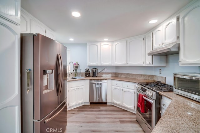 10025 Thornbird Ct, Moreno Valley, CA 92557 - kitchen featuring appliances with stainless steel finishes, under cabinet range hood, a sink, white cabinetry, and recessed lighting