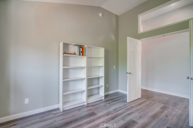 10025 Thornbird Ct, Moreno Valley, CA 92557 - unfurnished bedroom with wood finished floors, vaulted ceiling, and baseboards