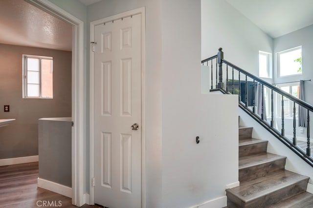 10025 Thornbird Ct, Moreno Valley, CA 92557 - staircase with baseboards and wood finished floors