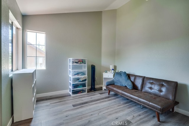 10025 Thornbird Ct, Moreno Valley, CA 92557 - living area with wood finished floors, baseboards, and a textured wall