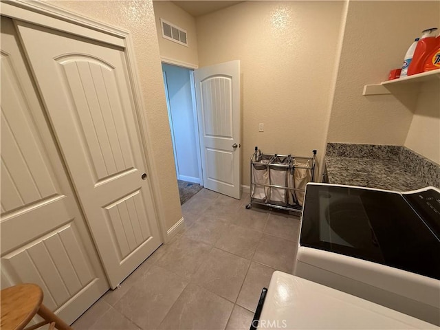 3751 De Soto Way, Merced, CA 95340 - laundry area featuring light tile patterned flooring and a textured wall
