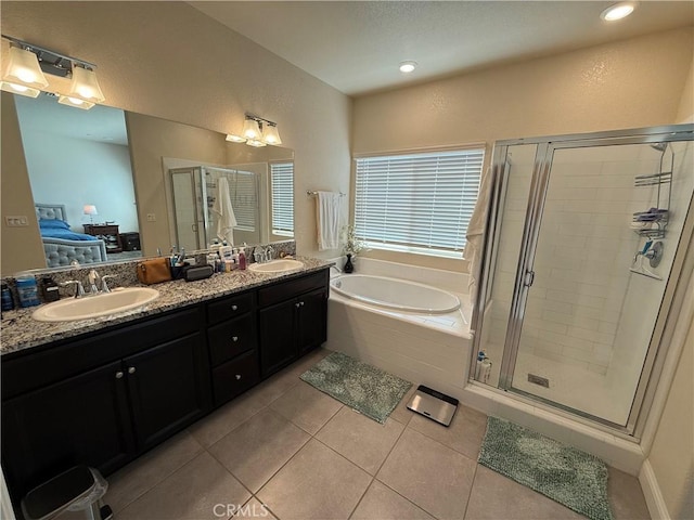 3751 De Soto Way, Merced, CA 95340 - full bathroom with tile patterned flooring, a bath, a shower stall, double vanity, and recessed lighting