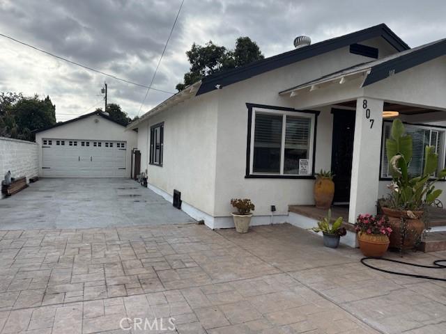 807 N Pearl Ave, Compton, CA 90221 - view of property exterior featuring stucco siding and a detached garage