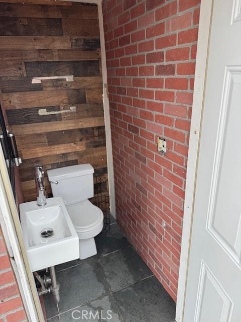 807 N Pearl Ave, Compton, CA 90221 - half bath with brick wall, toilet, tile patterned flooring, and a sink