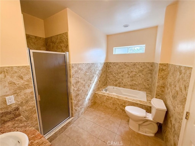 8921 Deer Trl, Frazier Park, CA 93225 - bathroom featuring tile walls, tile patterned flooring, toilet, a shower stall, and a garden tub
