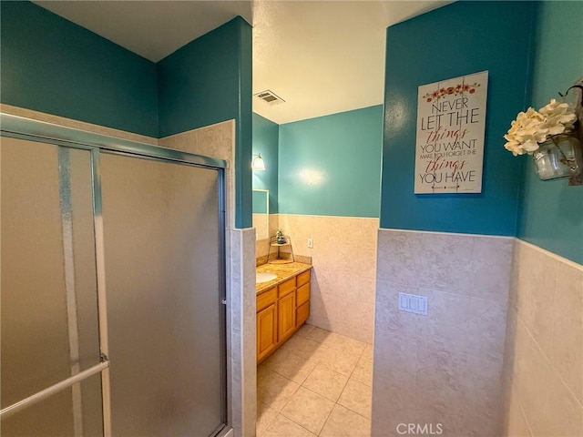 8921 Deer Trl, Frazier Park, CA 93225 - full bathroom with tile walls, tile patterned floors, wainscoting, a stall shower, and vanity