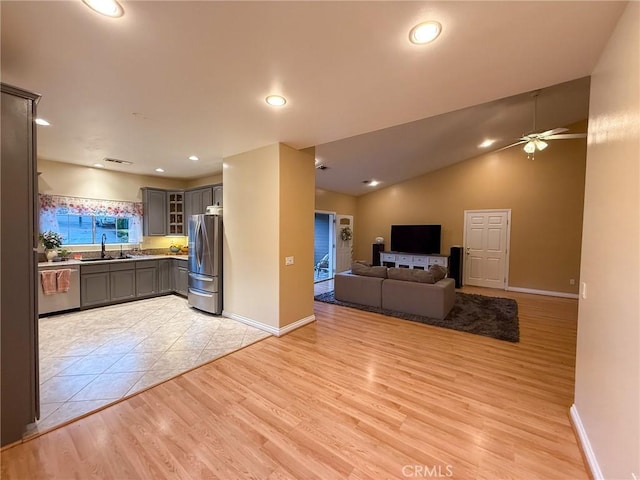 8921 Deer Trl, Frazier Park, CA 93225 - kitchen featuring stainless steel appliances, gray cabinetry, a sink, open floor plan, and a ceiling fan
