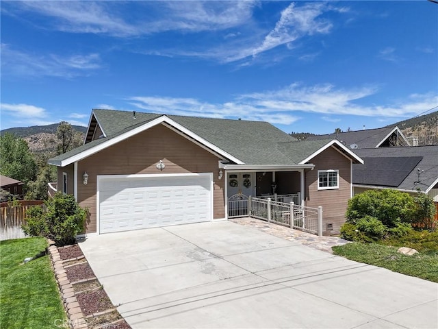 8921 Deer Trl, Frazier Park, CA 93225 - ranch-style home with an attached garage, fence, driveway, a shingled roof, and a mountain view