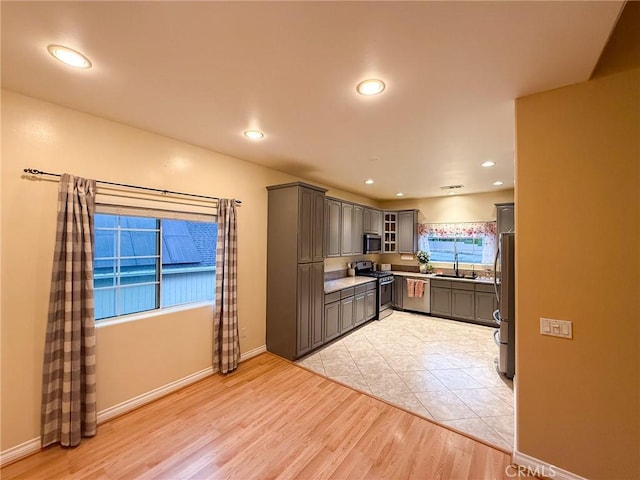 8921 Deer Trl, Frazier Park, CA 93225 - kitchen with appliances with stainless steel finishes, gray cabinets, glass insert cabinets, recessed lighting, and baseboards