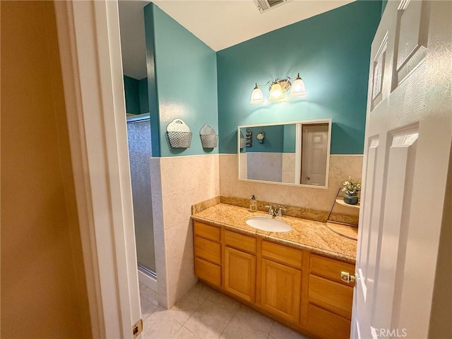 8921 Deer Trl, Frazier Park, CA 93225 - bathroom with tile patterned flooring, a shower stall, vanity, and tile walls