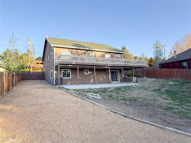 8921 Deer Trl, Frazier Park, CA 93225 - back of property with central air condition unit, a fenced backyard, a wooden deck, and a patio area