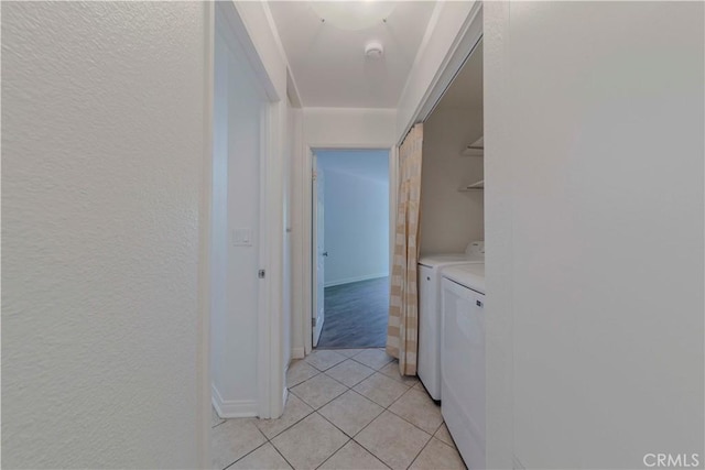4200 Via Arbolada Unit 123, Los Angeles, CA 90042 - washroom with light tile patterned floors, washing machine and clothes dryer, baseboards, and a textured wall