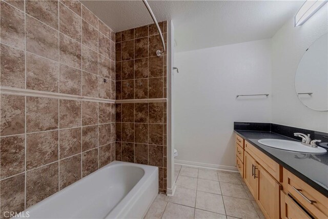 4200 Via Arbolada Unit 123, Los Angeles, CA 90042 - bathroom with tile patterned floors, vanity, a textured ceiling, toilet, and washtub / shower combination